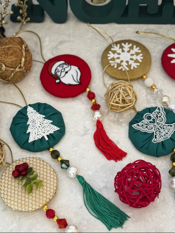 Collection of Christmas ornaments with 'NOEL' decoration in the background