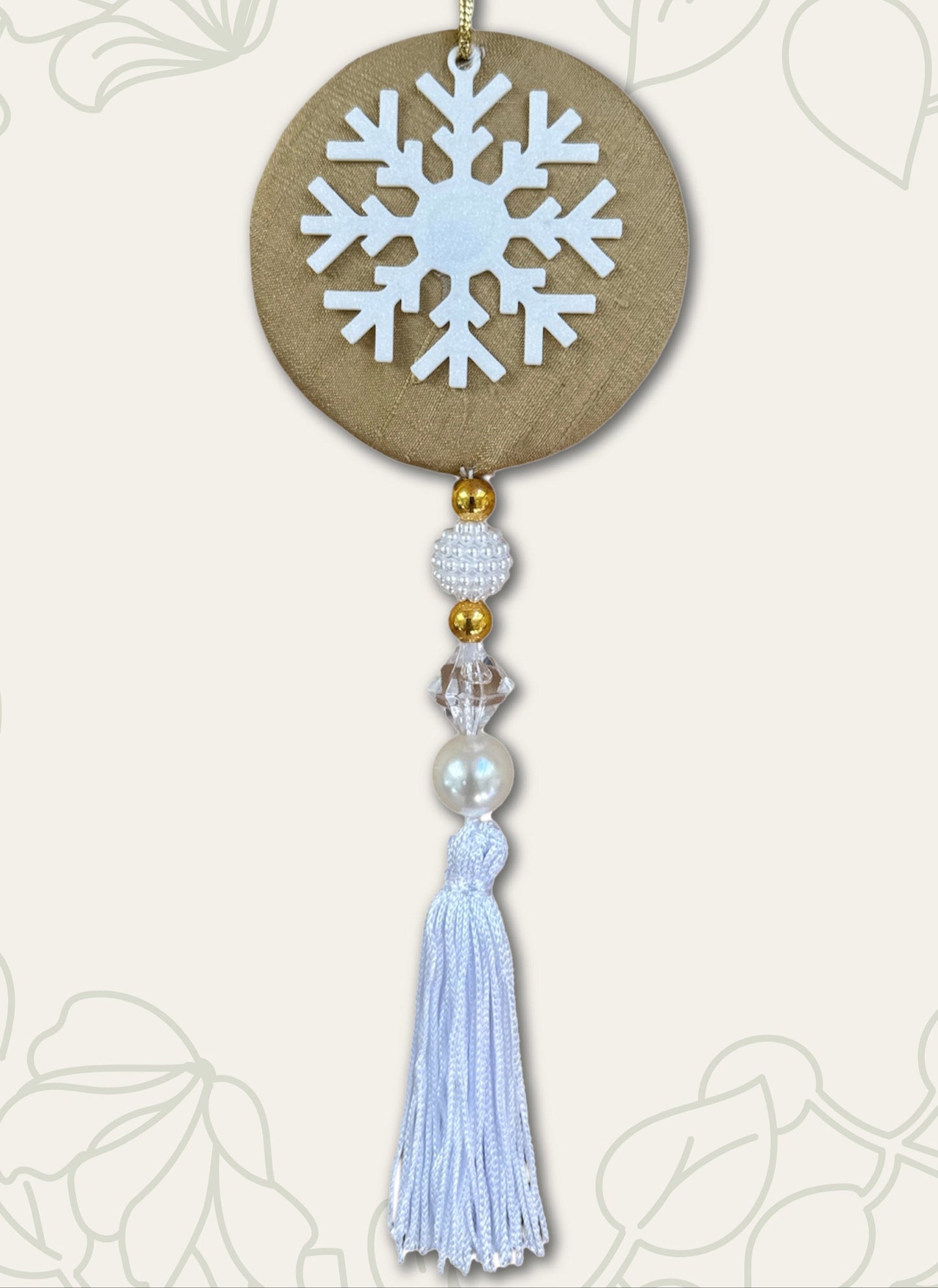 Decorative hanging ornament with snowflake design on a light background