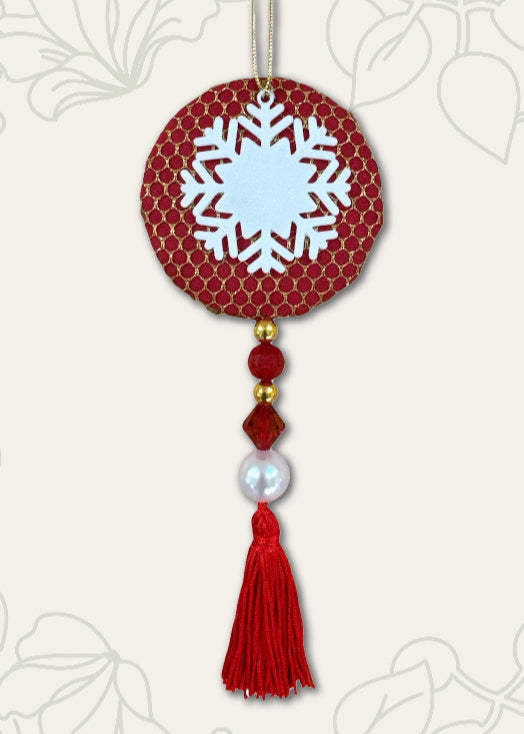 Decorative hanging ornament with snowflake design on a red background